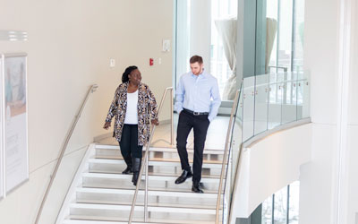 Whirlpool Employees chatting on staircase Whirlpool Employees chatting on staircase
